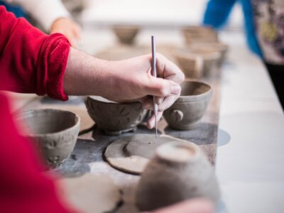 woman painting pottery